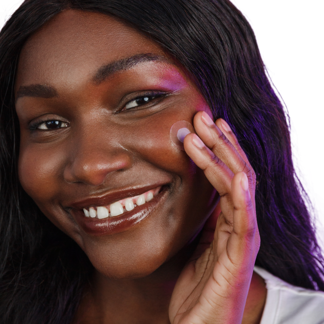 This image shows a lady applying her ESK Spotless pimple patch onto her cheek. To deliver a payload of evidence based ingredients directly onto the are of concern. This will ensure that the emerging pimple heals faster, reduces redness and longevity of the pimple. Zap your acne right from the source.